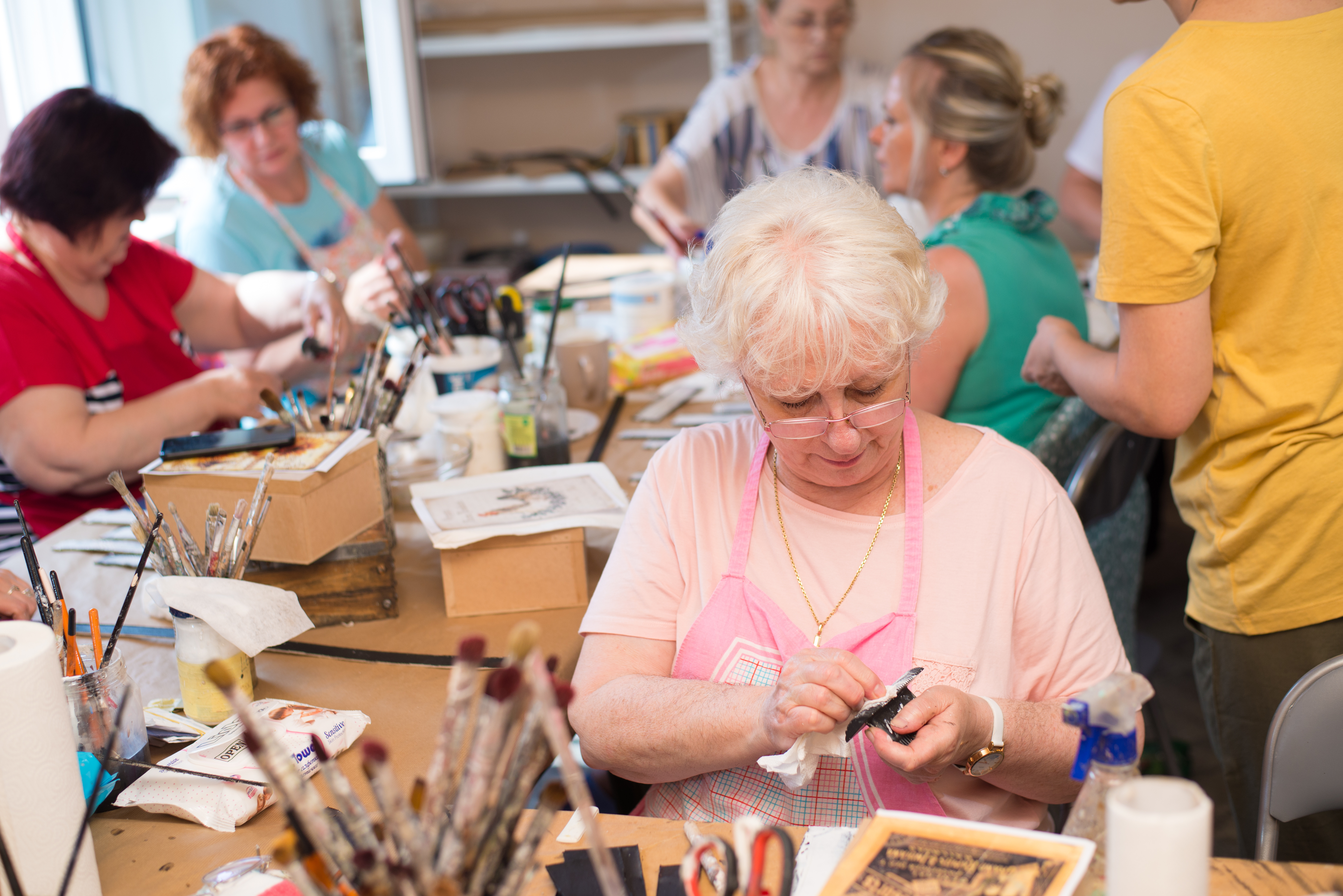 Group of women working on craft projects.