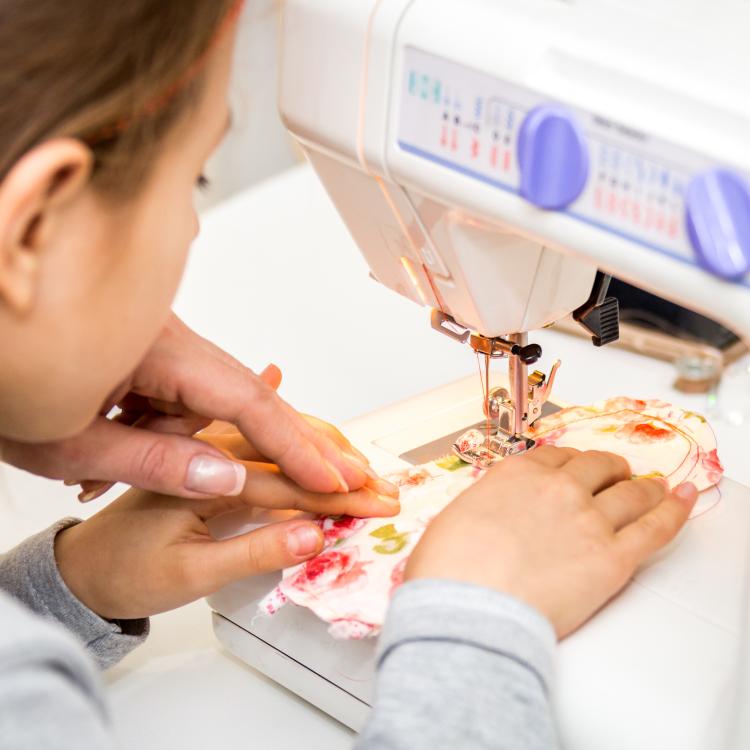  kid using sewing machine