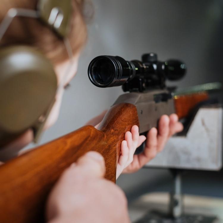  Student Shooting Rifle at Target