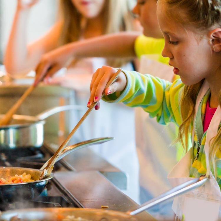  Young student cooking on stove