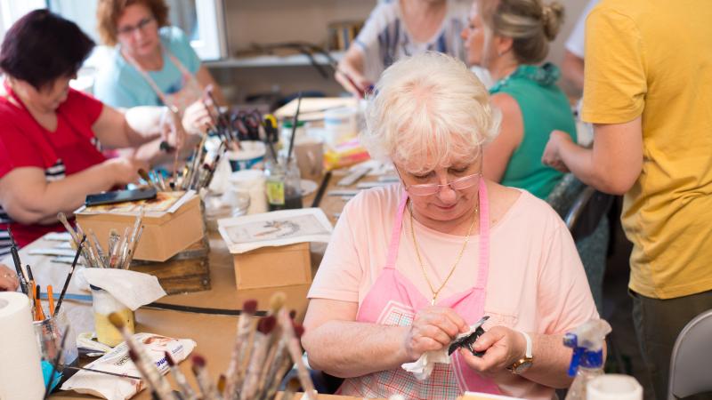 Group of women working on craft projects.